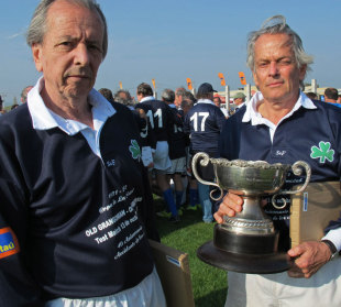 Survivors of the Andes plane crash Daniel Fernandez and Eduardo Strauch hold a commemorative trophy during a rugby game to mark the 40th anniversary of the incident, Santiago, Chile, October 13, 2012
