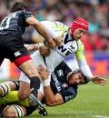 The Ospreys' Richard Fussell is halted by the Tigers
