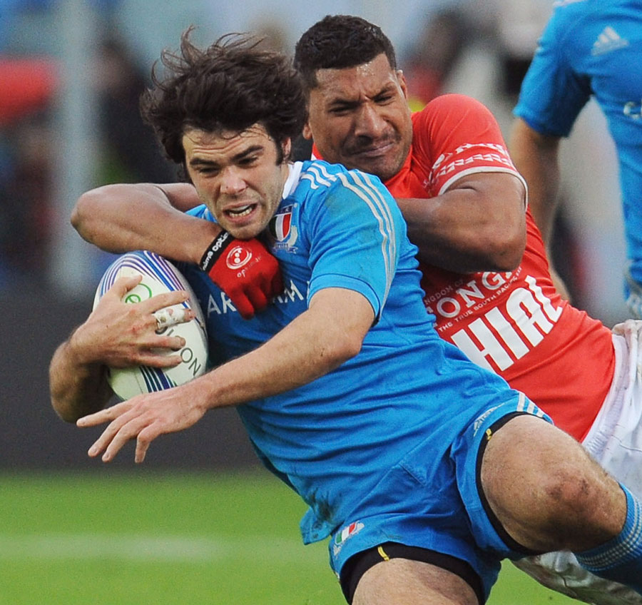 Italy's Luke McLean is tackled by Steve Mafi of Tonga