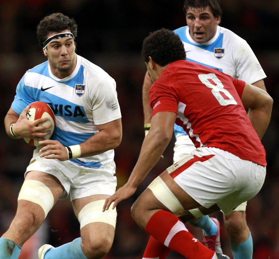 Argentina's Manuel Carizza is confronted by Wales' Toby Faletau