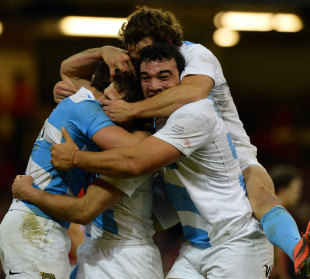 Argentina's Juan Imhoff is engulfed after scoring a try, Wales v Argentina, Millennium Stadium, Cardiff, Wales, November 10, 2012