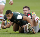 Northampton's Luther Burrell tries to escape from Tom Guest's tackle