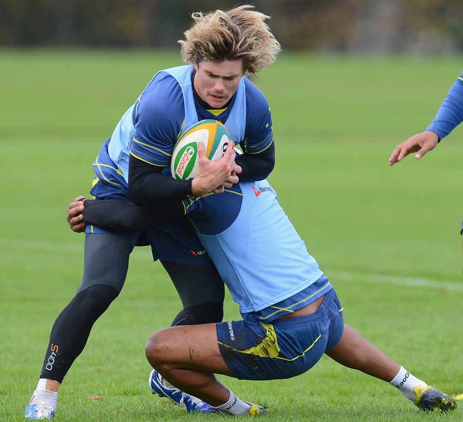 Australia's Berrick Barnes is tackled by Ben Tapuai in training