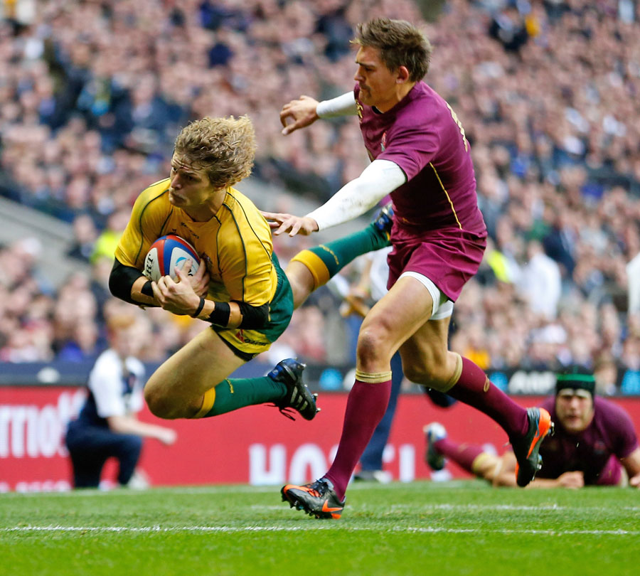 Australia's Nick Cummins dives over to score a try