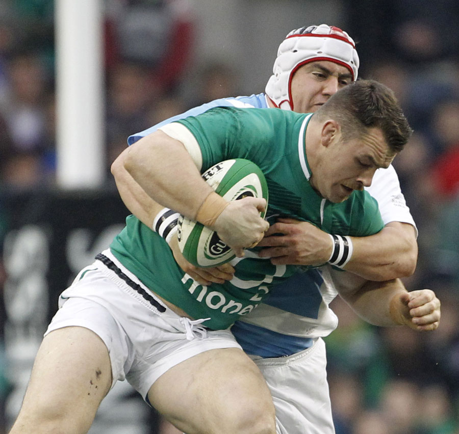 Cian Healy fights off an Argentinian tackler