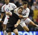 England's fly-half Toby Flood high-tackles New Zealand's scrum-half Jimmy Cowan