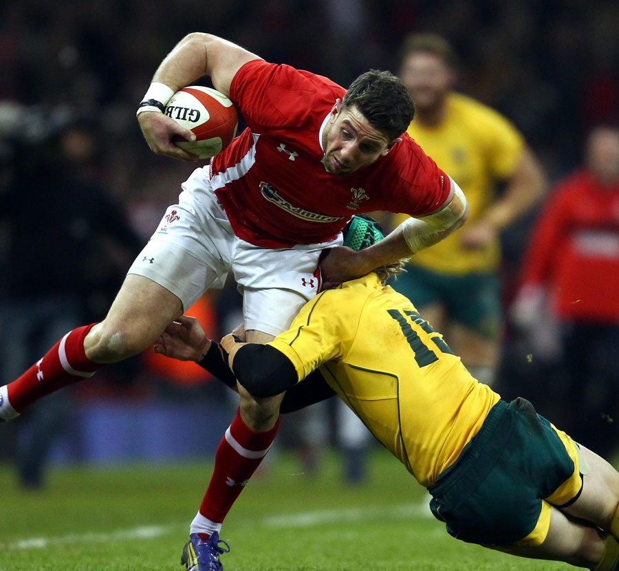 Wales' Alex Cuthbert is tackled by Australia's Berrick Barnes