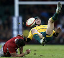 Australia's Berrick Barnes is upended by a Welsh tackle