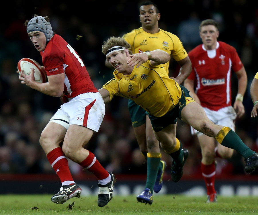 Australia's David Pocock stretches out to tackle Wales' Jonathan Davies