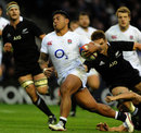 England's Manu Tuilagi attempts to break through the New Zealand defence