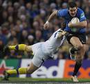 Leinster's Jonathan Sexton charges past Morgan Parra