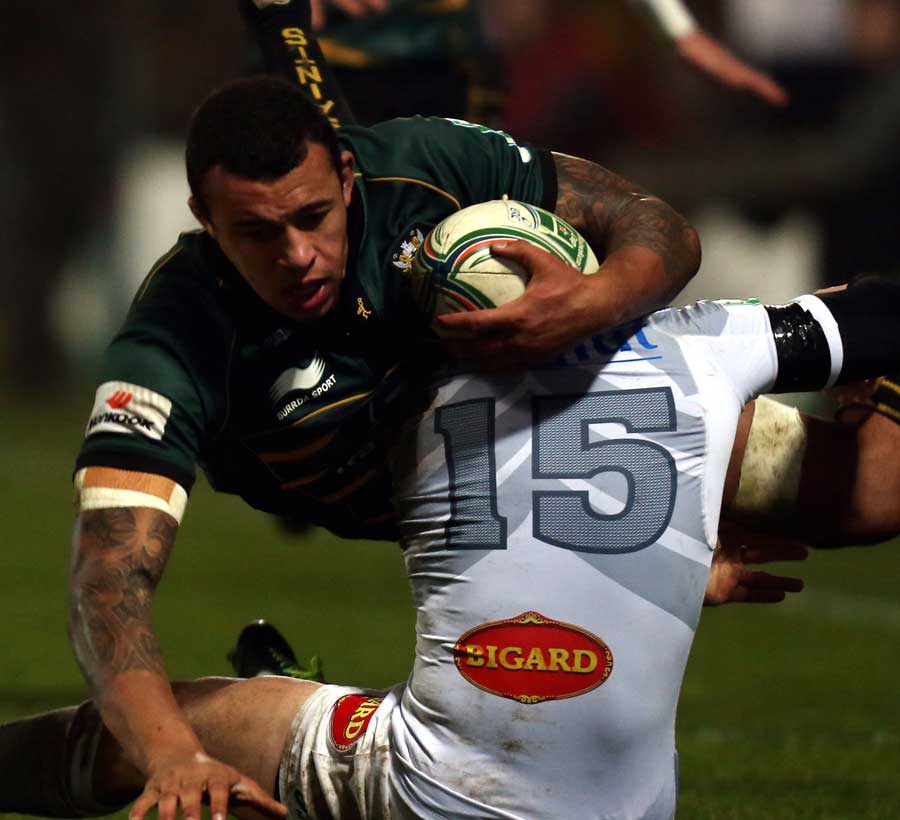 Northampton Saints' Courtney Lawes is tackled by Brice Dulin