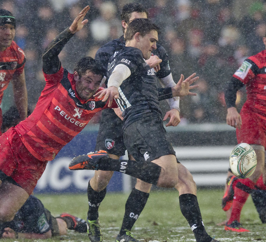 Leicester's Toby Flood clears the ball under pressure