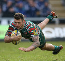 Leicester's Adam Thompstone dives over for a try 