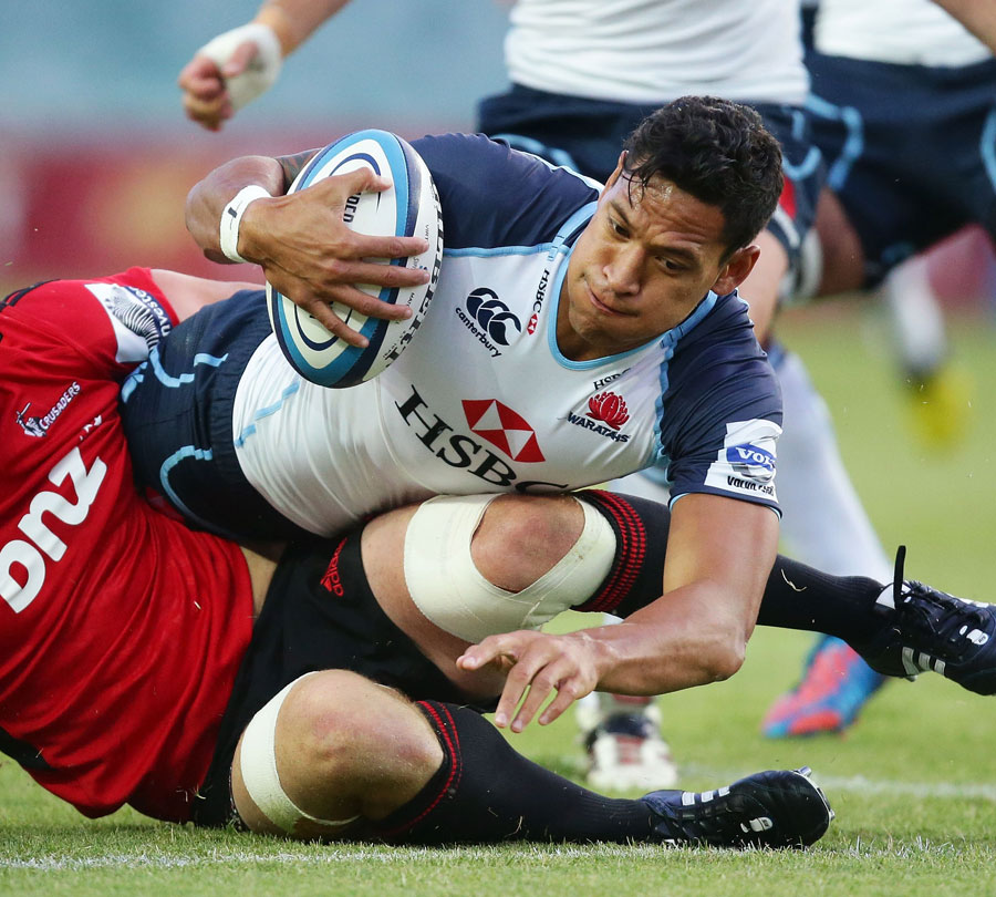 The Waratahs' Israel Folau is felled by the Crusaders' defence