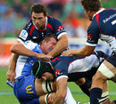 The Force's Angus Cottrell is swamped by Rebels tacklers