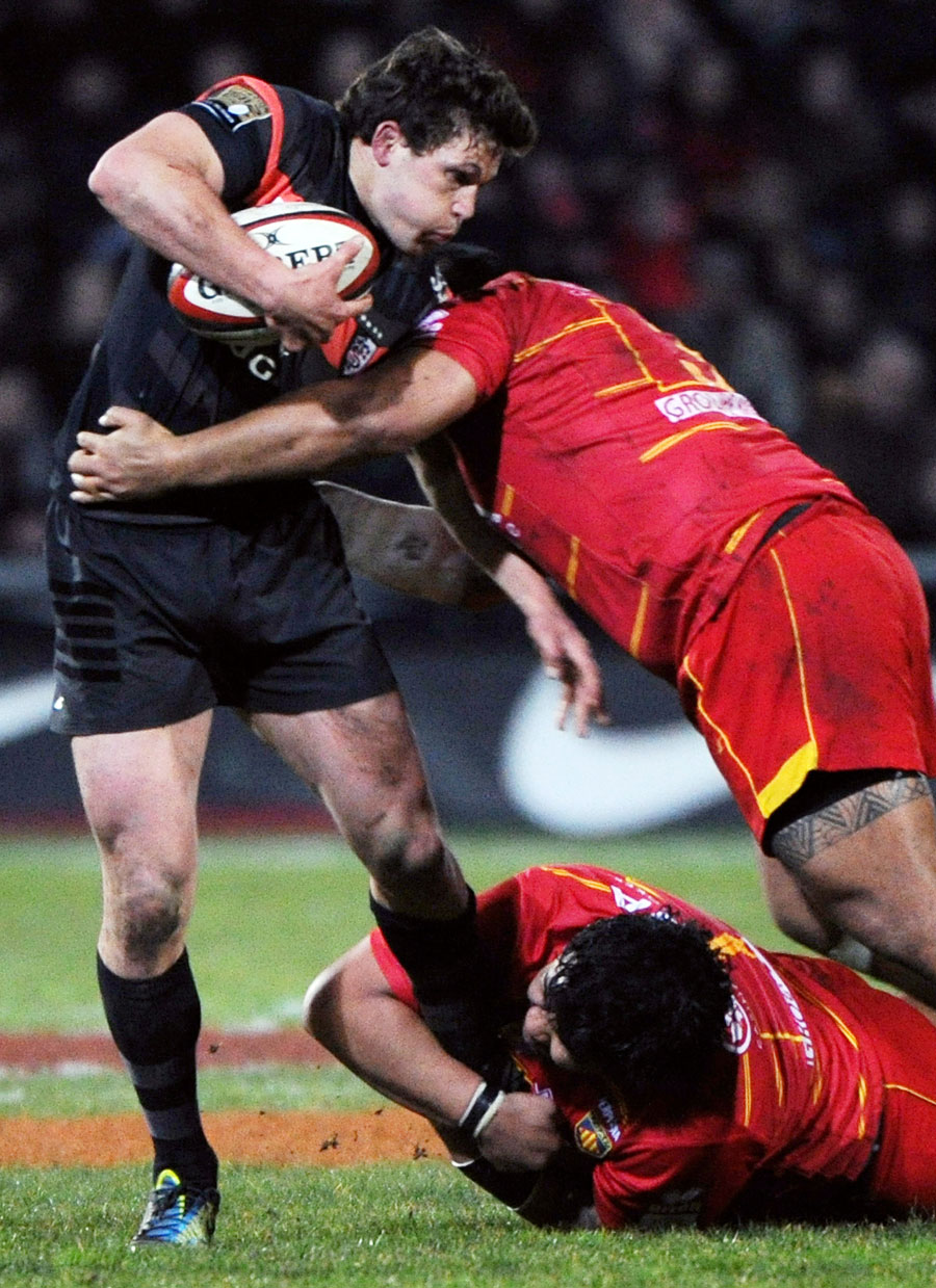 Toulouse's Luke Burgess is shackled by the Perpignan defence