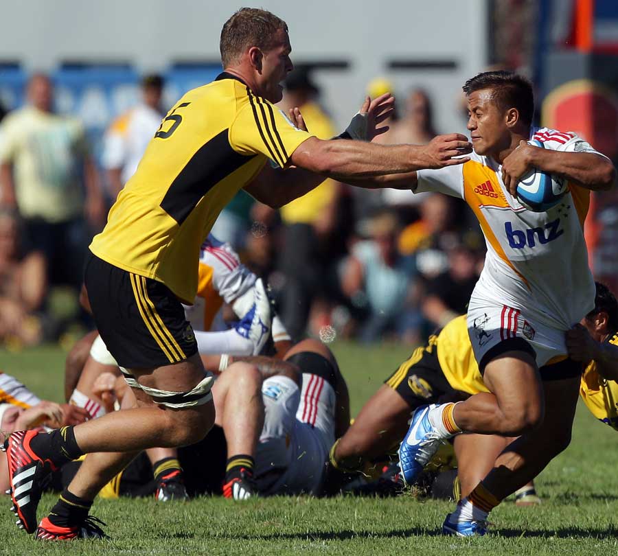 Tim Nanai-Williams of the Chiefs fends off James Broadhurst of the Hurricanes