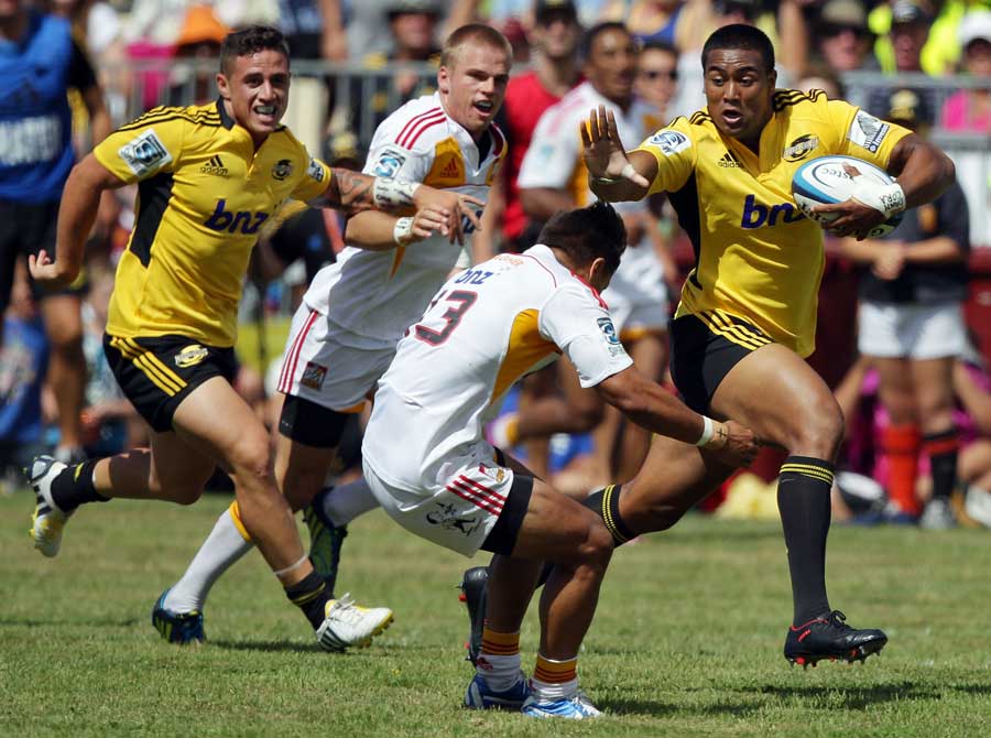 The Hurricanes' Julian Savea fends Tim Nanai-Williams of the Chiefs during the Super Rugby trial match between the Hurricanes and the Chiefs at Mangatainoka.