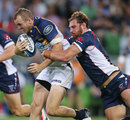 The Brumbies Jesse Mogg is tackled by the Rebels' Scott Higginbotham