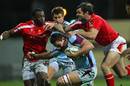 Bourgoin's Sylvain Nicolas is held by the Worcester defence
