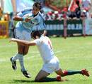 Portugal's Vasco Uva tackles Argentina's Dino Tomas Caceres