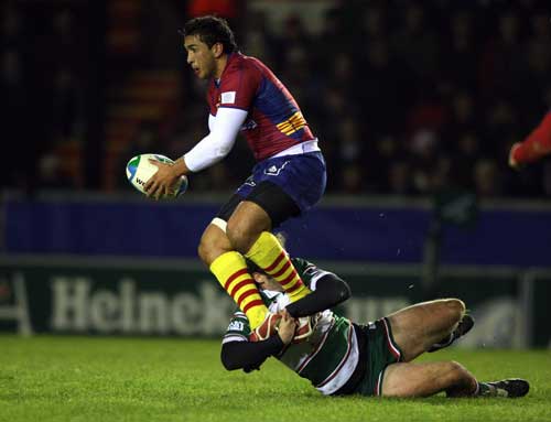 Perpigan centre Maxime Mermoz is tackled by Leicester's Julien Dupuy