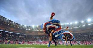 Moulin Rouge dancers perform on the field before the start of the Heineken Cup clash between Stade Francais and Harlequins at the Stade de France in Saint-Denis, outside Paris on December 6, 2008. 