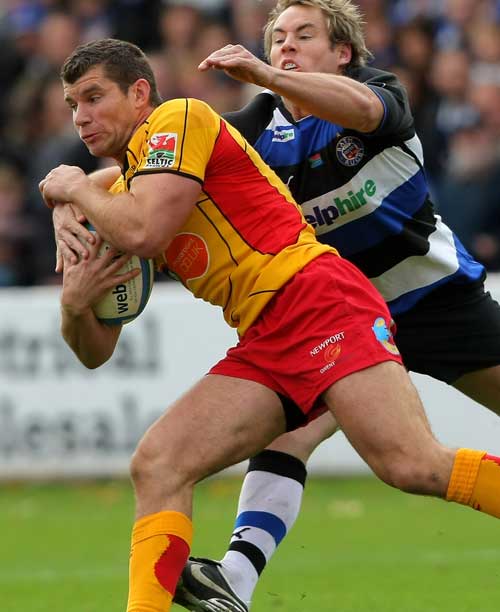 The Dragons' Marc Stcherbina is tackled by Bath's Butch James