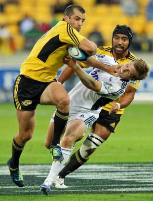 The Hurricanes' Conrad Smith fends off the Blues' Chris Noakes, Hurricanes v Blues, Super Rugby, Westpac Stadium, Wellington, New Zealand, February 23, 2013