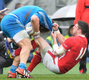 Wales' Alex Cuthbert pulls Italy's Martin Castrogiovanni to the ground