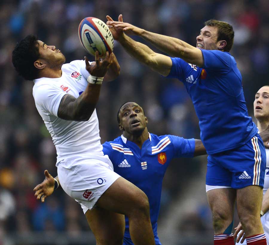 England's Manu Tuilagi vies for the high ball with France's Vincent Clerc