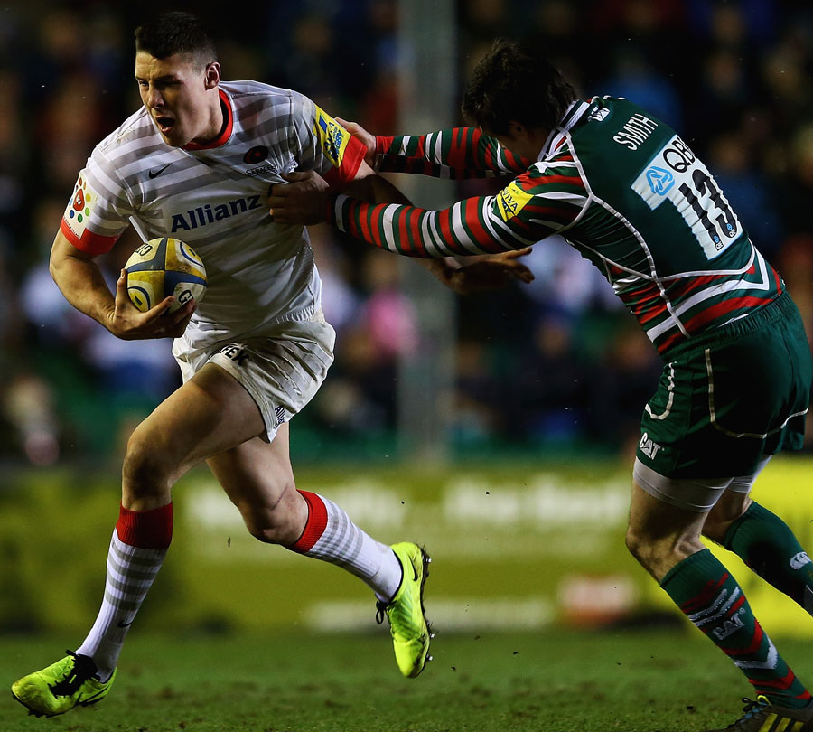 Saracens' Joel Tomkins tries to evade Leicester's Matt Smith