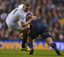 England's Chris Ashton is felled by the Scotland defence