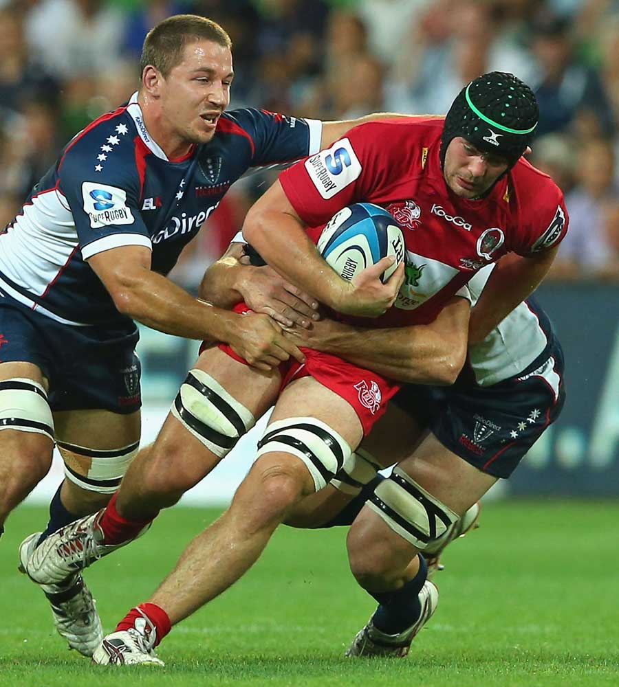 The Reds' Liam Gill is tackled by Melbourne opponents
