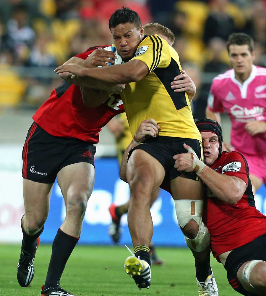 The Hurricanes' Alapati Leuia is tackled by Crusaders opponents