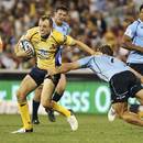 The Brumbies' Jesse Mogg fends off a Waratahs tackle