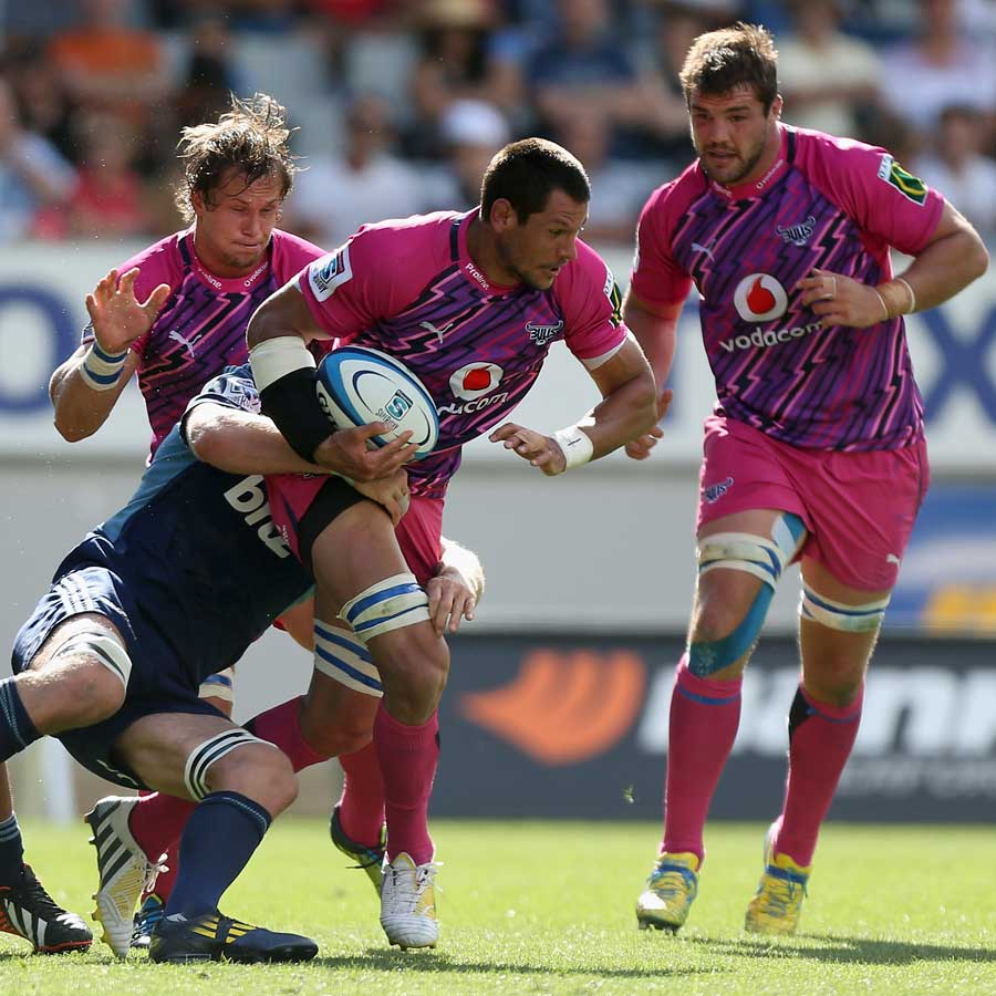 The Bulls' Pierre Spies powers through a Blues tackle