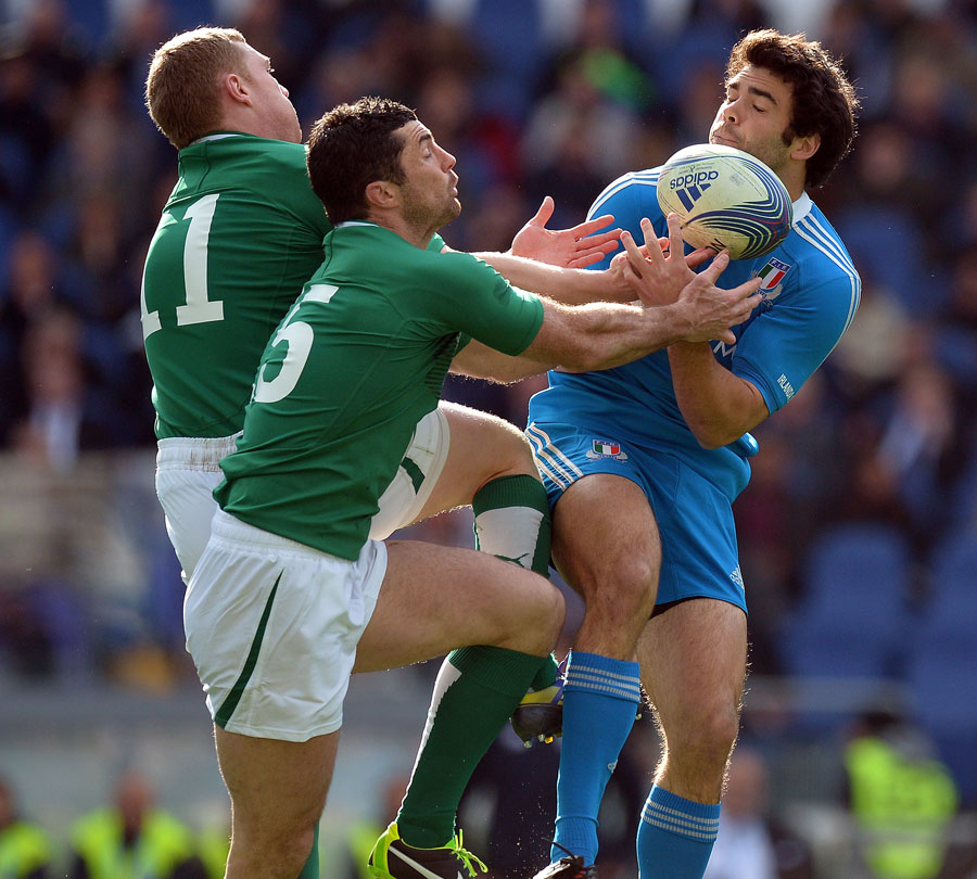 Ireland's Rob Kearney and Keith Earls compete with Italy's Luke McLean