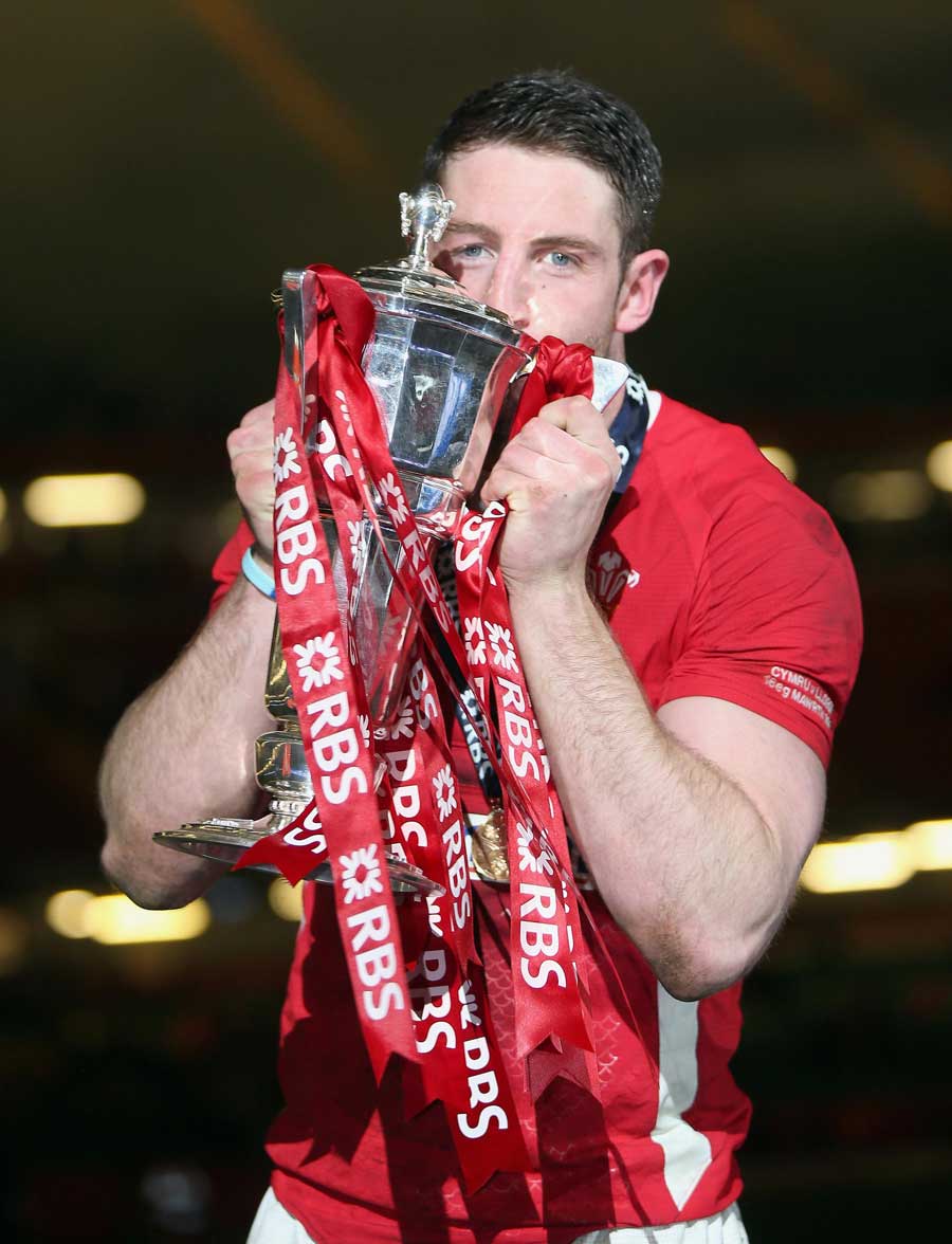Wales' two-try hero Alex Cuthbert celebrates with the trophy