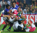 England's Dan Norton is wrapped up by the Samoa defence