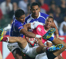 England's Dan Norton is wrapped up by the Samoa defence