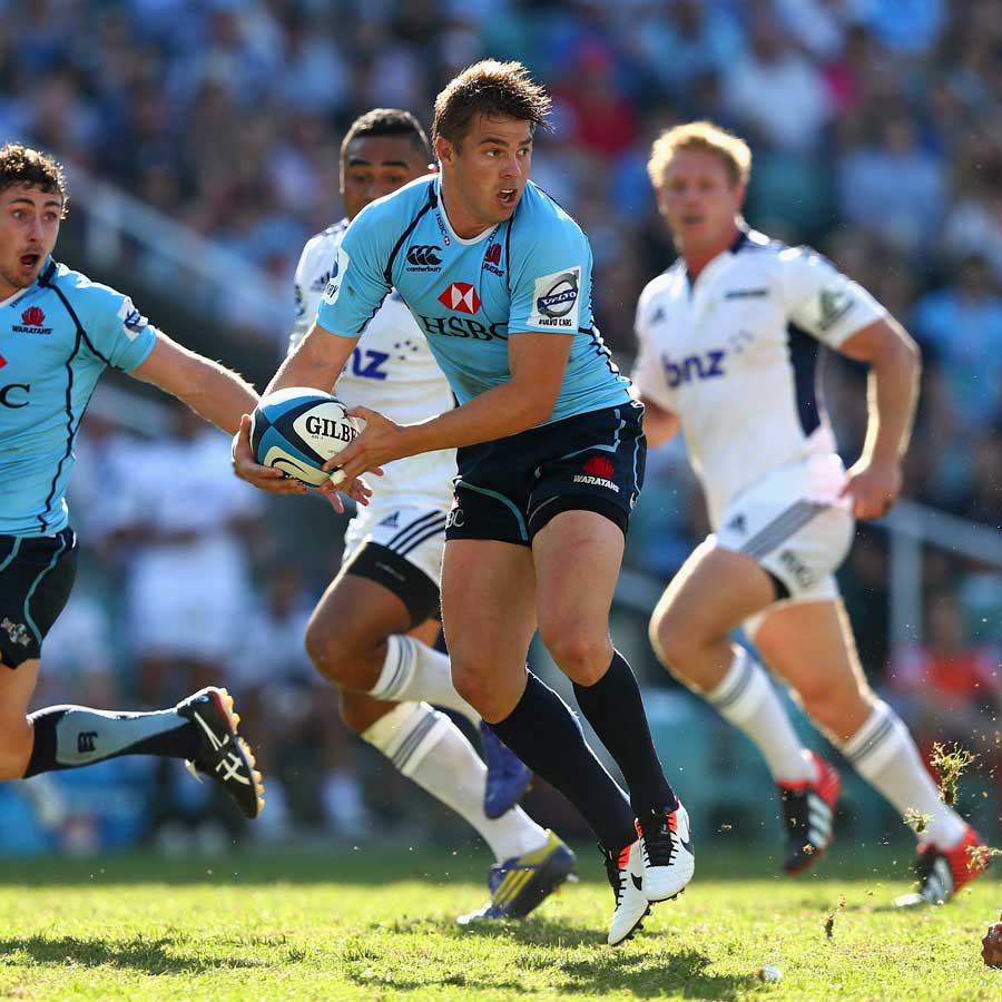 The Waratahs' Drew Mitchell passes the ball against the Blues