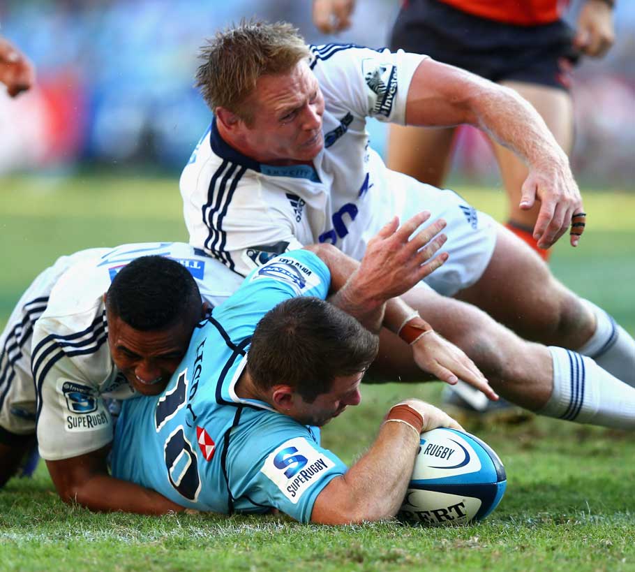 Waratahs fly-half Bernard Foley goes over for a try against the Blues