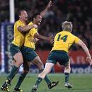Kurtley Beale celebrates with team-mates Quade Cooper (l) and James O'Connor (r)
