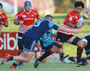 Yoshitaka Tokunaga of Japan is tackled during the Pacific Rugby Cup in Auckland