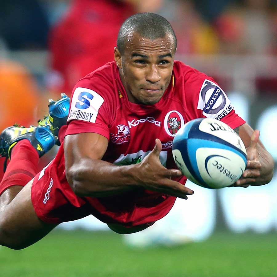 The Reds' Will Genia passes the ball against the Highlanders