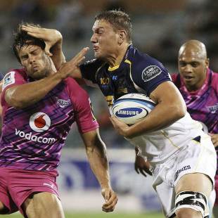 The Brumbies' Etienne Oosthuizen fends off the Bulls' Jan Serfontein, Brumbies v Bulls, Super Rugby, Canberra Stadium, Canberra, March 30, 2013