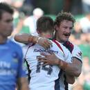 The Rebels' Scott Higginbotham congratulates Jason Woodward for his try against the Force