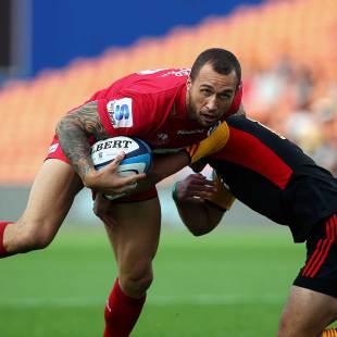 The Reds' Quade Cooper beats the tackle of the Chiefs' Aaron Cruden, Chiefs v Queensland Reds, Super Rugby, Waikato Stadium, Hamilton, April 13, 2013
